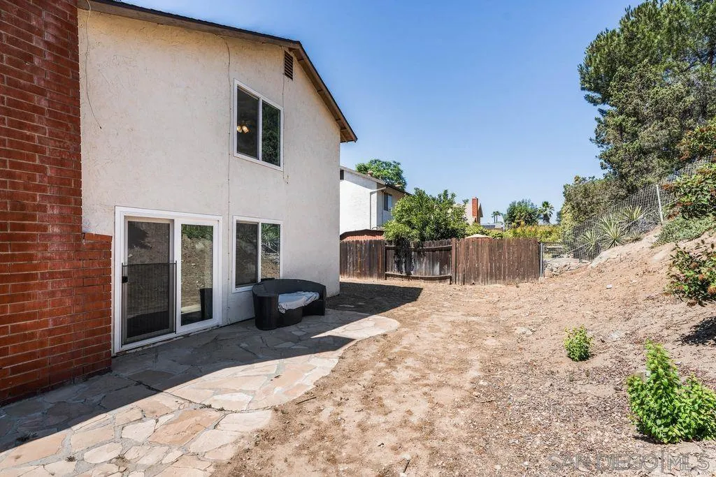 8659 Cordial Road El Cajon, CA 92021 - Photo 13 of 16 a front view of a house with a yard