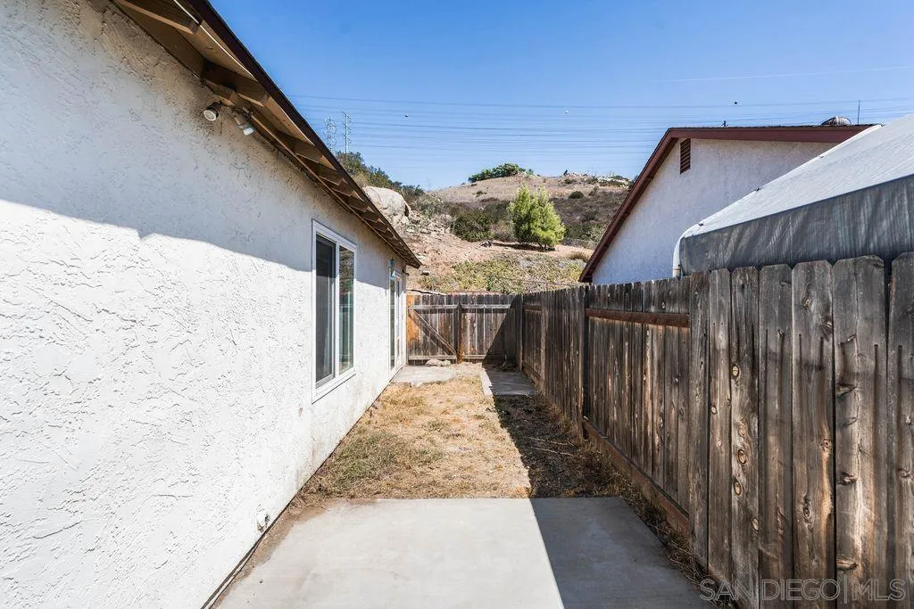 8659 Cordial Road El Cajon, CA 92021 - Photo 15 of 16 a view of a pathway of a house with wooden fence