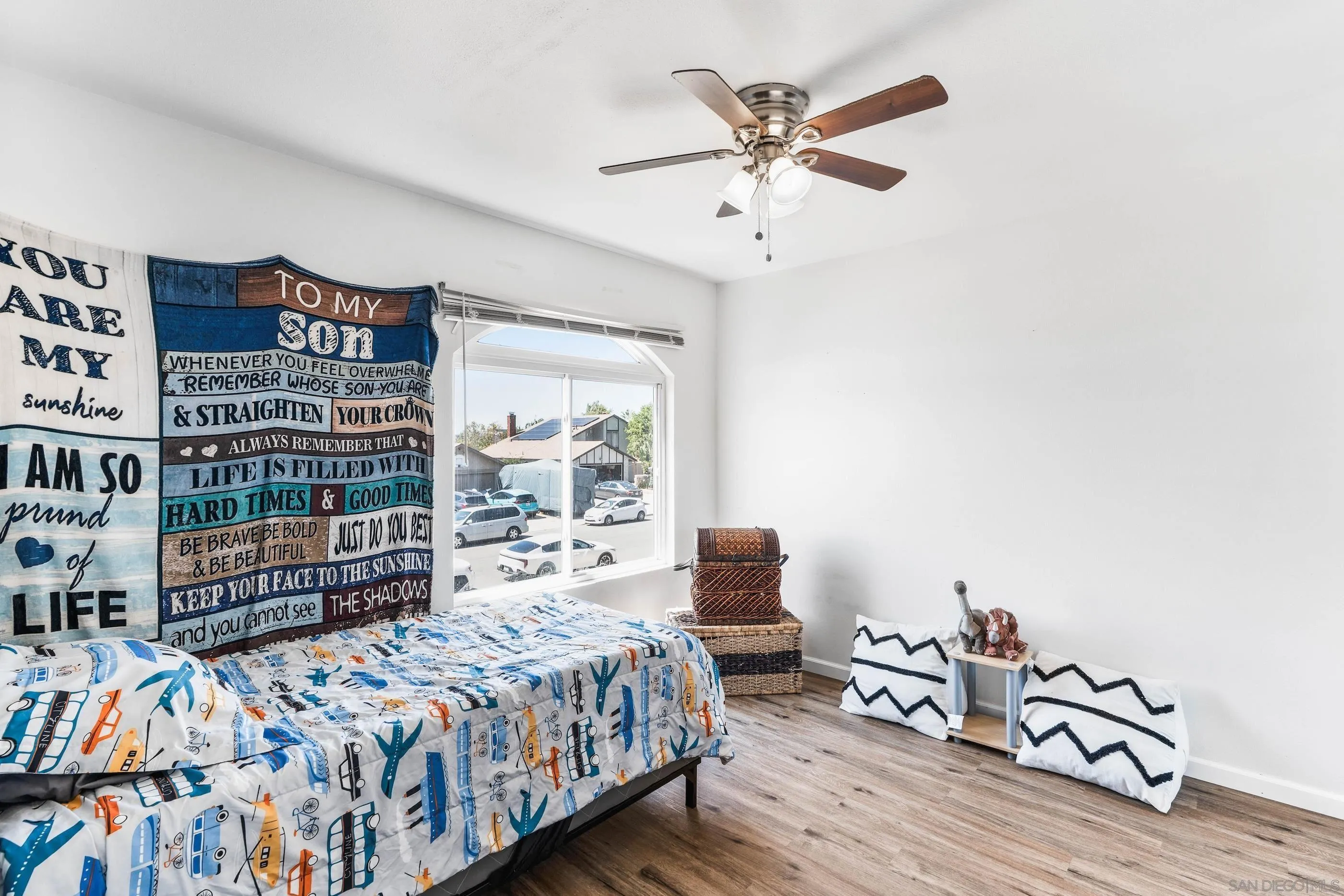 8659 Cordial Road El Cajon, CA 92021 - Photo 16 of 16 a bedroom with a bed bookshelf and a large window