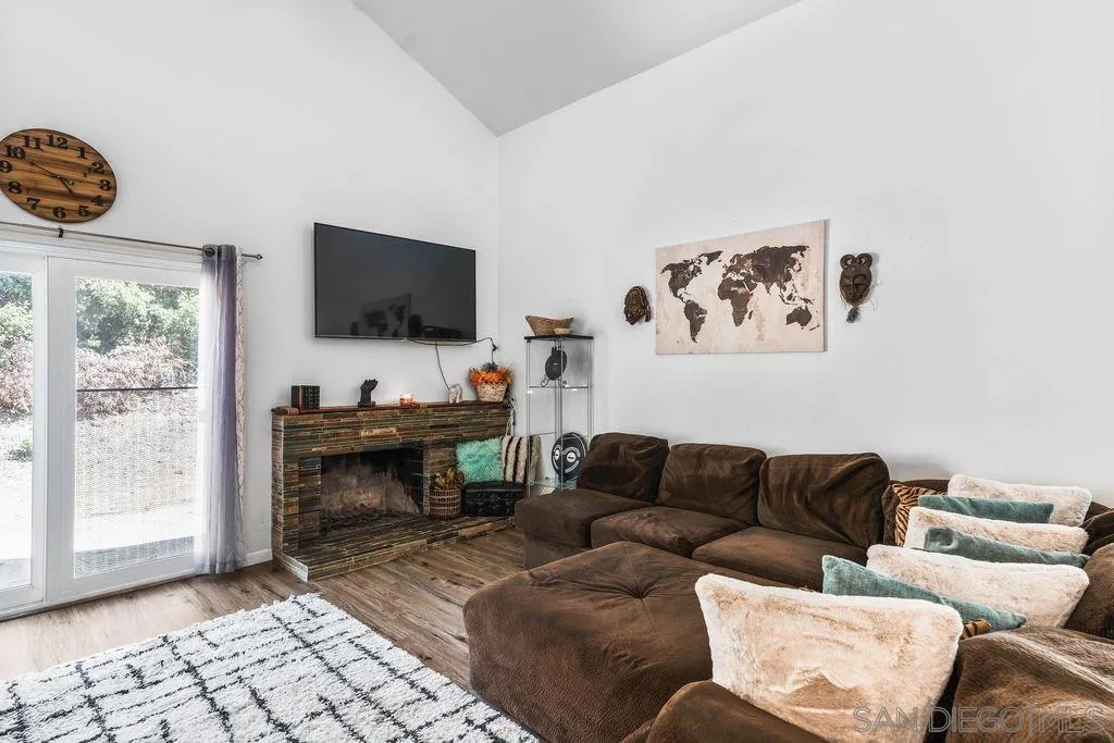 8659 Cordial Road El Cajon, CA 92021 - Photo 3 of 16 a living room with furniture a flat screen tv and a window