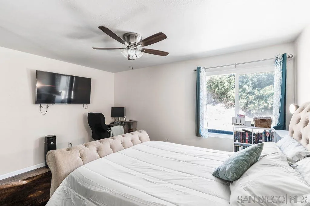 8659 Cordial Road El Cajon, CA 92021 - Photo 4 of 16 a bedroom with a bed window and a flat screen tv