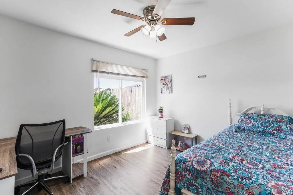 8659 Cordial Road El Cajon, CA 92021 - Photo 5 of 16 a bedroom with a bed and a chair