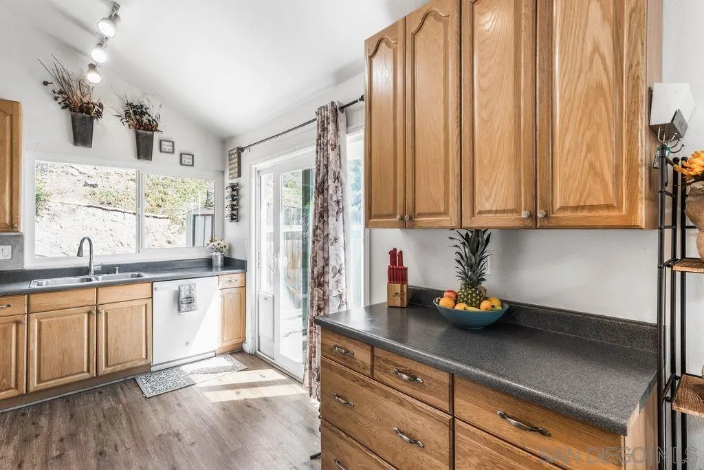 8659 Cordial Road El Cajon, CA 92021 - Photo 8 of 16 a kitchen with stainless steel appliances a refrigerator sink and cabinets
