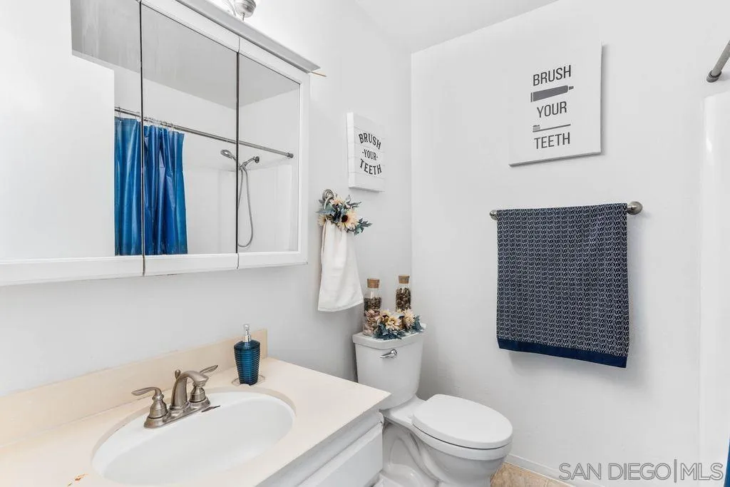 8659 Cordial Road El Cajon, CA 92021 - Photo 10 of 16 a bathroom with a sink a toilet and shower