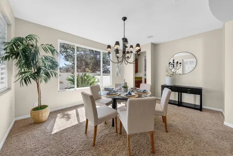 a view of a dining room with furniture window and outside view