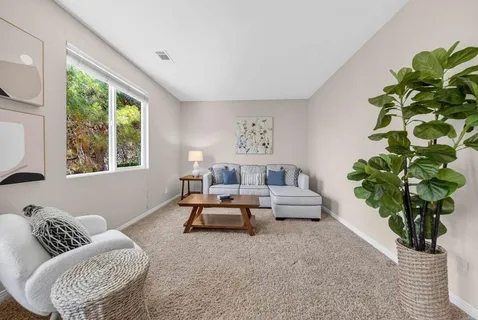 a white bath tub sitting in a bathroom next to a window