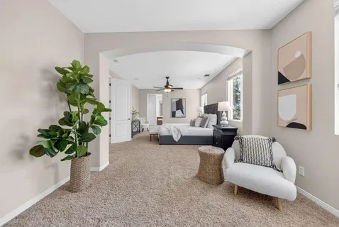 a spacious bathroom with a tub sink and mirror
