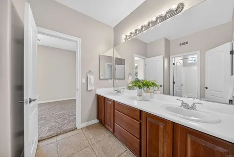 a view of a patio with table and chairs under an umbrella
