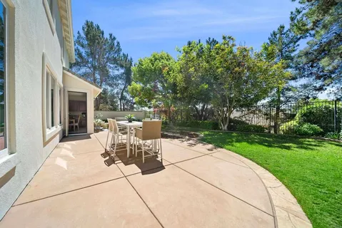 an aerial view of a house with garden space and street view