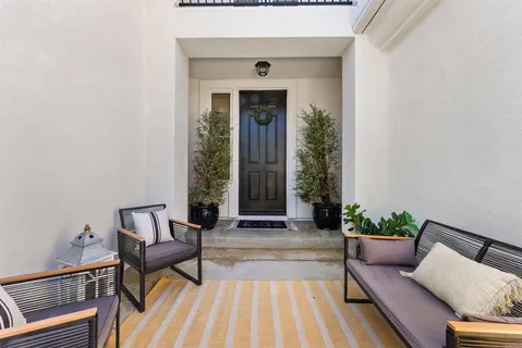 a living room with furniture and a potted plant