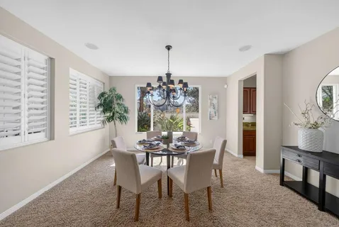 a dining room with furniture window and wooden floor