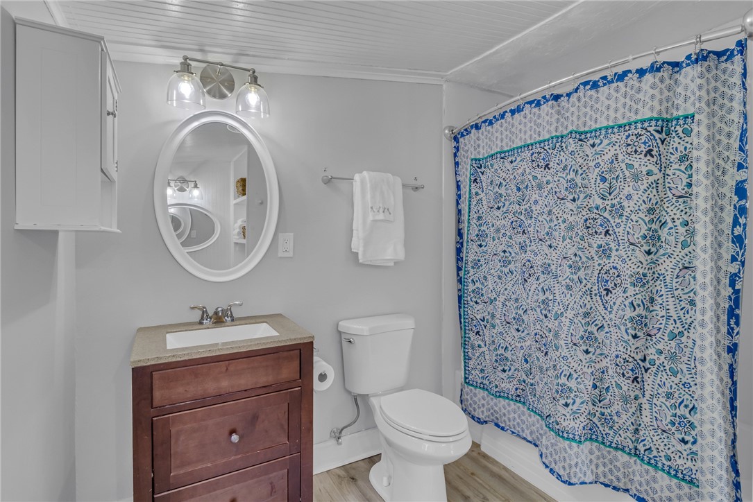 97 Virginia Road Irvington, VA 22480 - Photo 10 of 39 Full bathroom featuring light wood-type flooring, vanity, and a shower with curtain