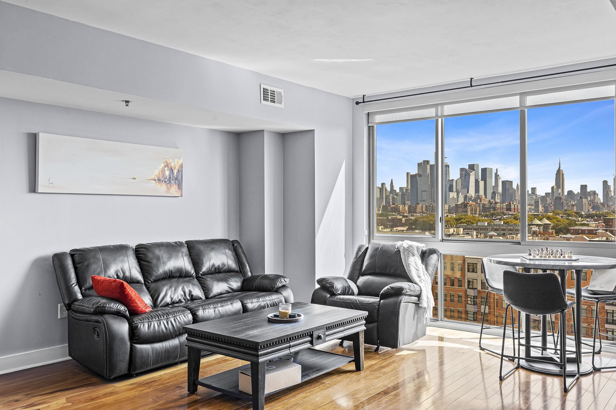 800 Jackson Street, Unit PH7 Hoboken, NJ 07030 - Photo 1 of 22 a living room with furniture and a large window
