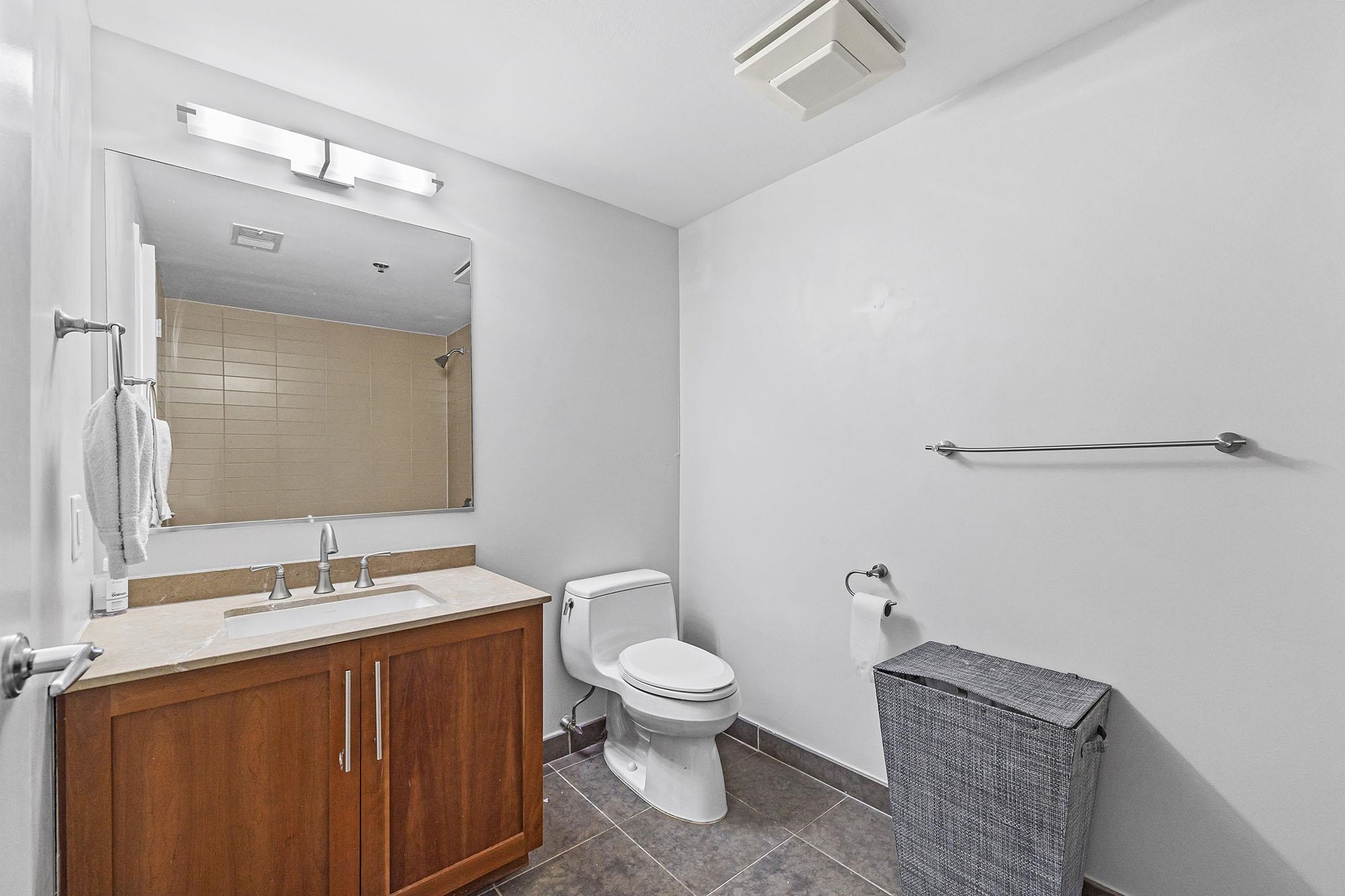 800 Jackson Street, Unit PH7 Hoboken, NJ 07030 - Photo 14 of 22 a bathroom with a granite countertop sink toilet a large mirror and shower