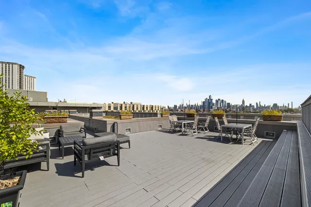 a terrace with outdoor seating and city view