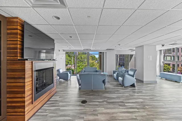 a living room with furniture large window and fireplace