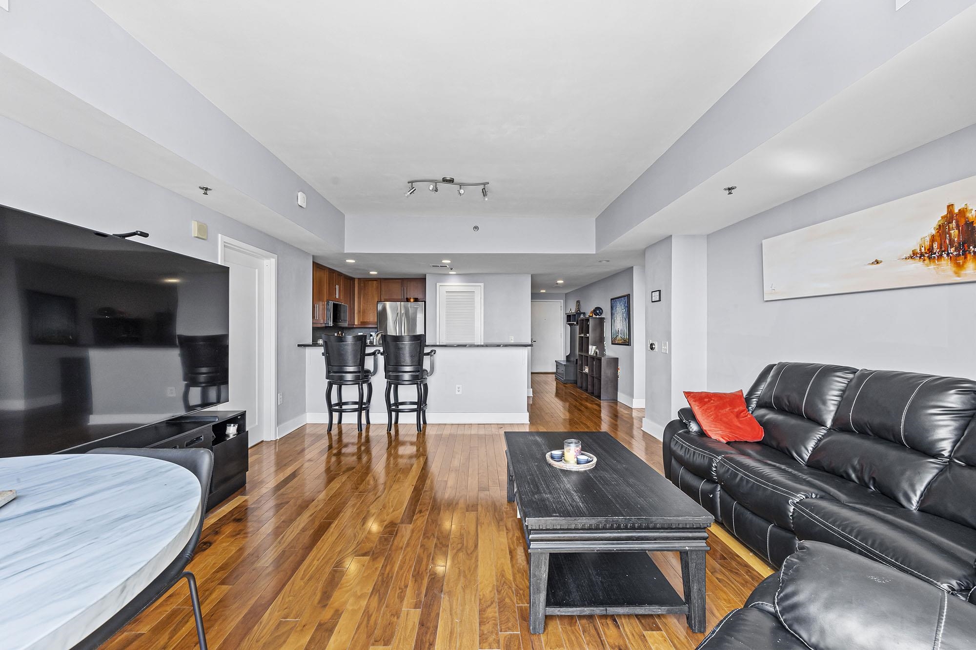 800 Jackson Street, Unit PH7 Hoboken, NJ 07030 - Photo 3 of 22 a living room with furniture and a wooden floor