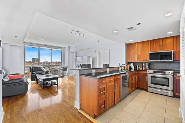 a kitchen with stainless steel appliances granite countertop a stove and a refrigerator