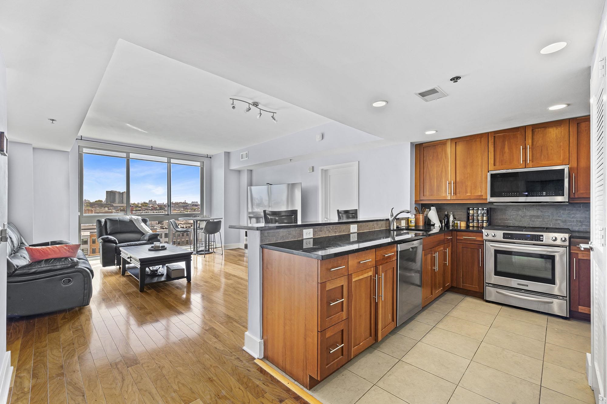 800 Jackson Street, Unit PH7 Hoboken, NJ 07030 - Photo 4 of 22 a kitchen with stainless steel appliances granite countertop a stove and a refrigerator