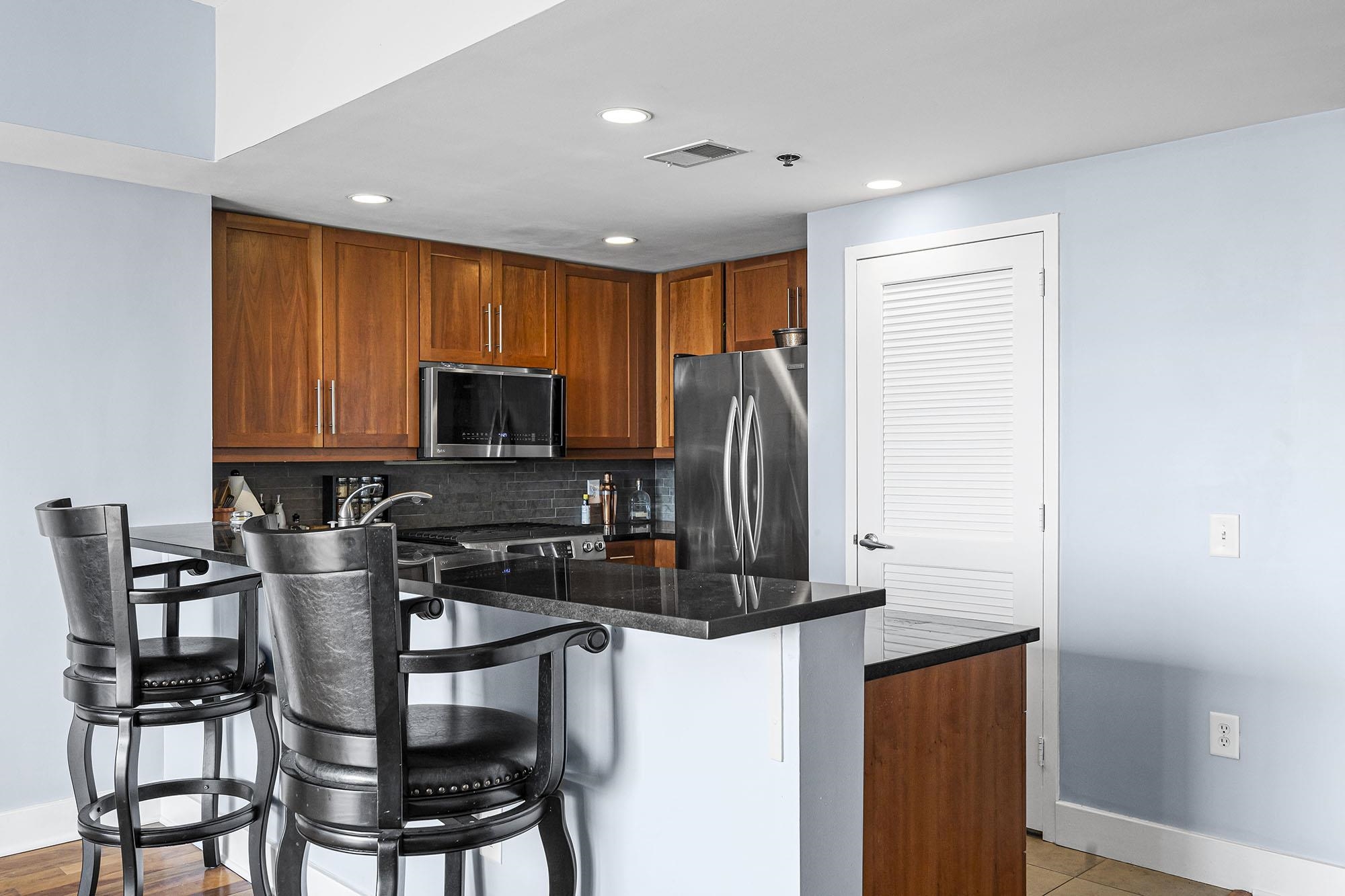 800 Jackson Street, Unit PH7 Hoboken, NJ 07030 - Photo 6 of 22 a kitchen with stainless steel appliances granite countertop a stove top oven a sink and a microwave