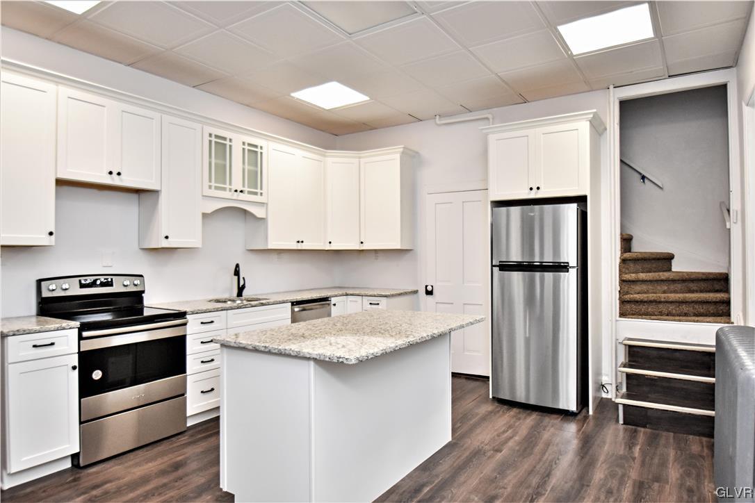 28 South 5th Street Emmaus, PA 18049 - Photo 11 of 23 a kitchen with white cabinets and appliances