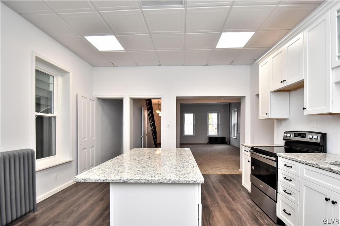 28 South 5th Street Emmaus, PA 18049 - Photo 9 of 23 a kitchen with stainless steel appliances granite countertop a stove a sink and a refrigerator