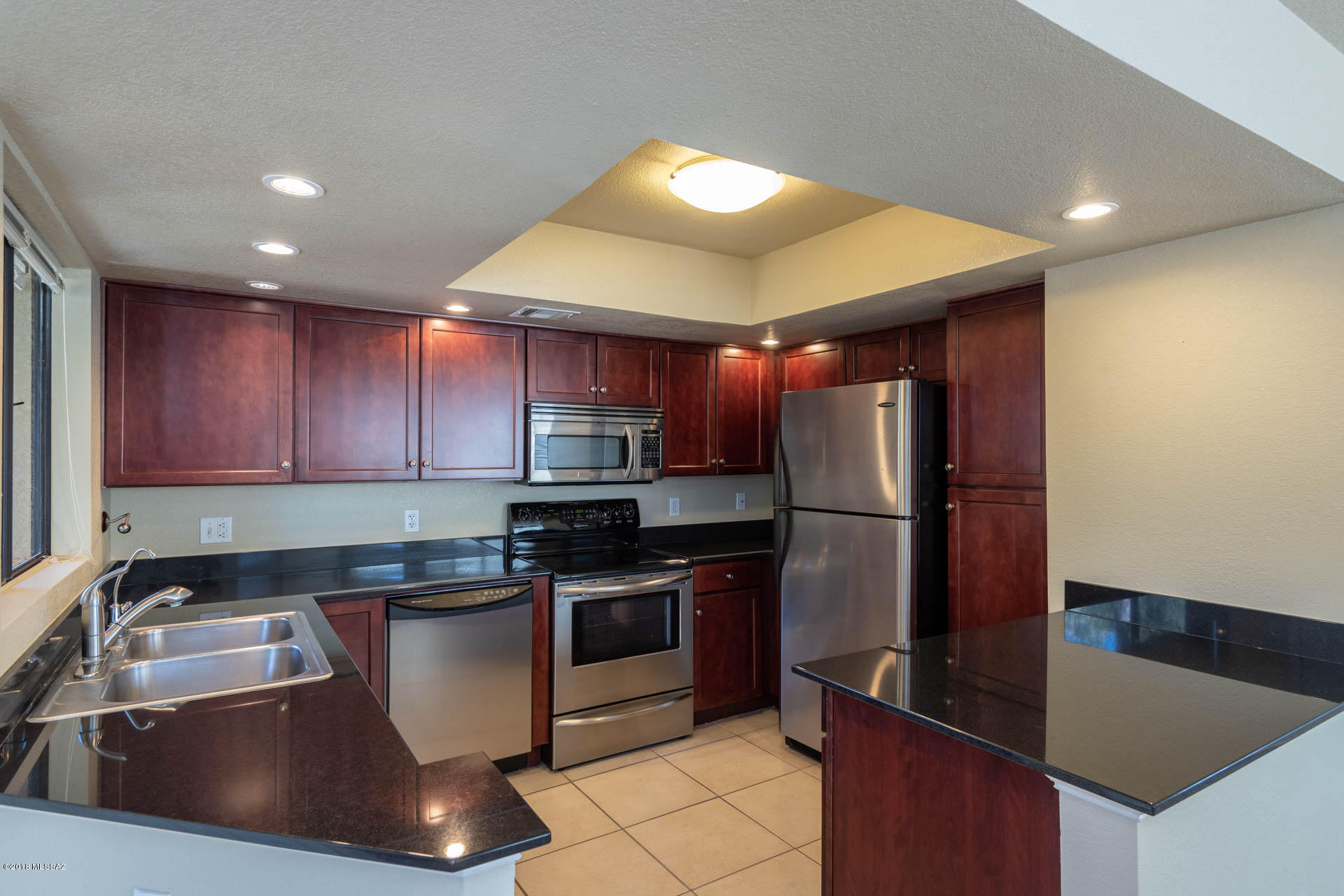 7255 East Snyder Road, Unit 8205 Tucson, AZ 85750 - Photo 2 of 23 a kitchen with stainless steel appliances granite countertop a sink a stove a refrigerator a counter top space and cabinets
