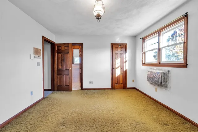 a view of an empty room with a fireplace