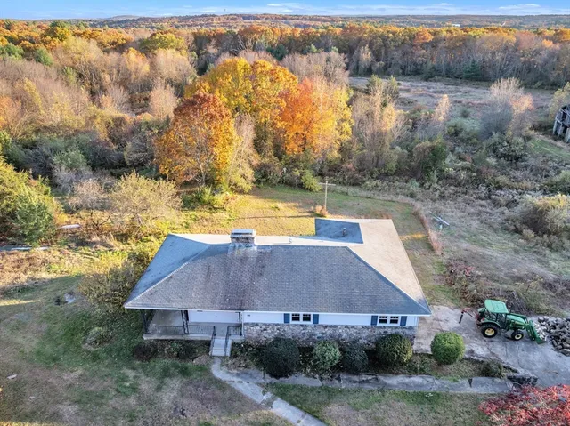 a view of a house with a yard and trees