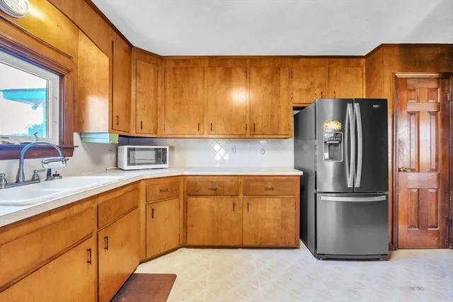 a kitchen with stainless steel appliances granite countertop a refrigerator and a sink