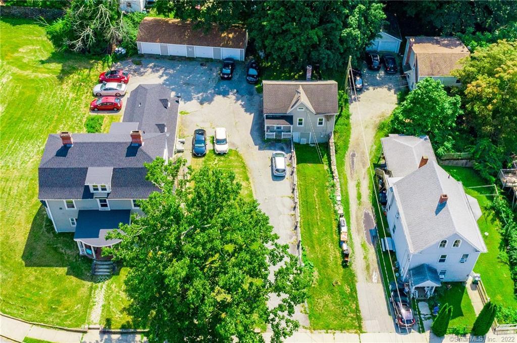 an aerial view of a house with a garden and lots of trees