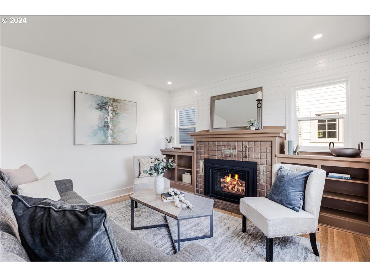 2639 North Sumner Street Portland, OR 97217 - Photo 13 of 46 a living room with furniture and a fireplace