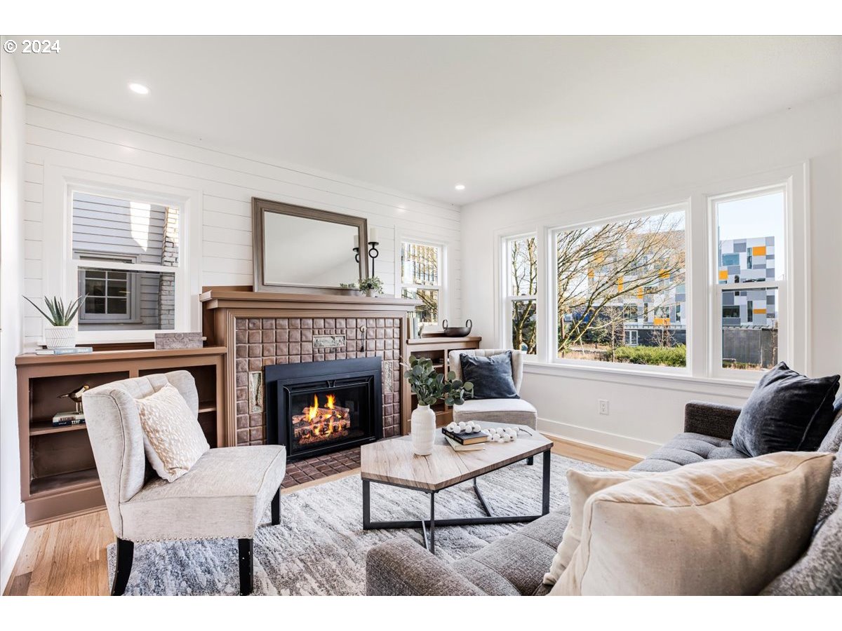 2639 North Sumner Street Portland, OR 97217 - Photo 14 of 46 a living room with furniture and a fireplace