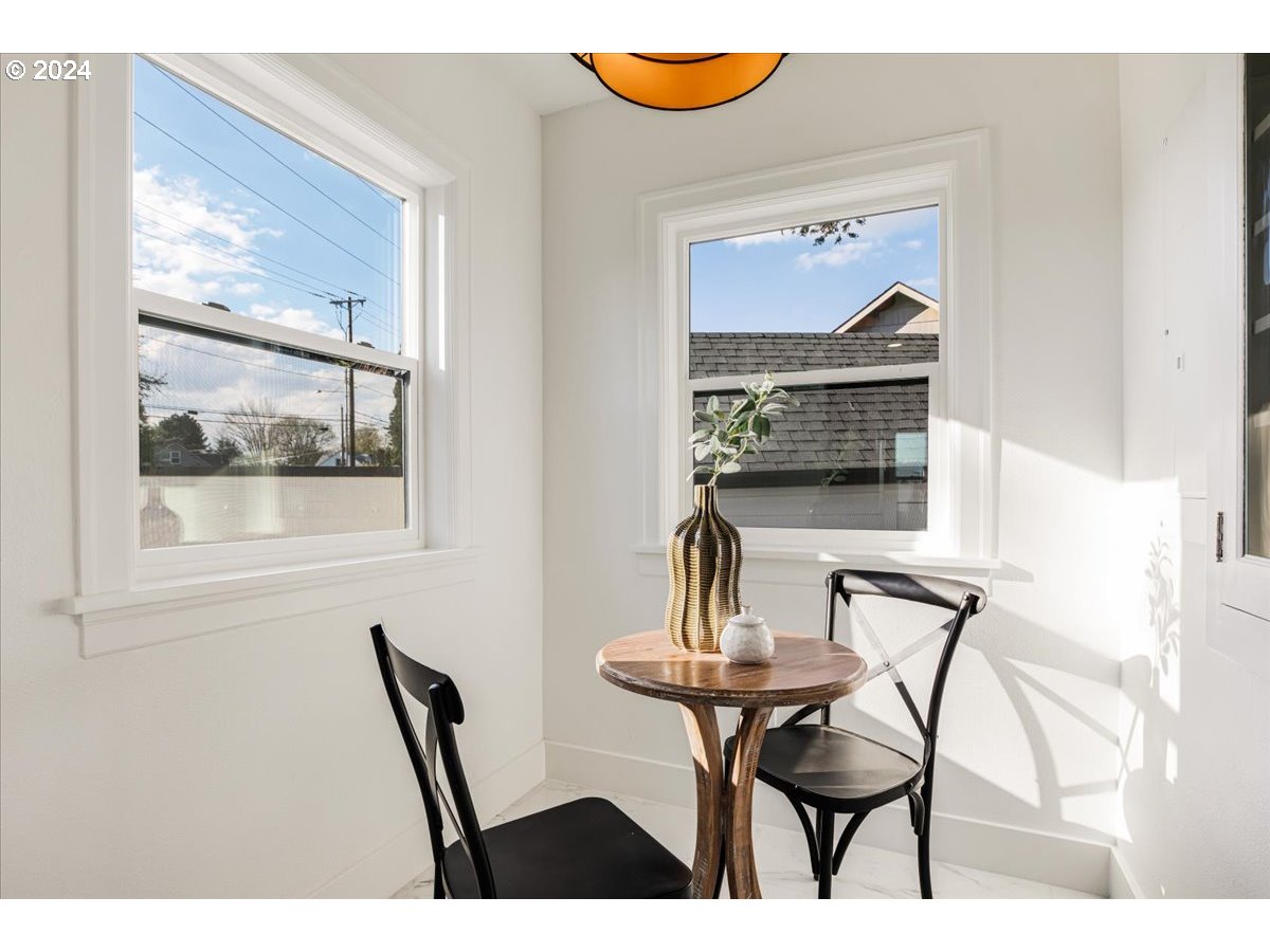 2639 North Sumner Street Portland, OR 97217 - Photo 18 of 46 a view of a dining room with furniture and a painting