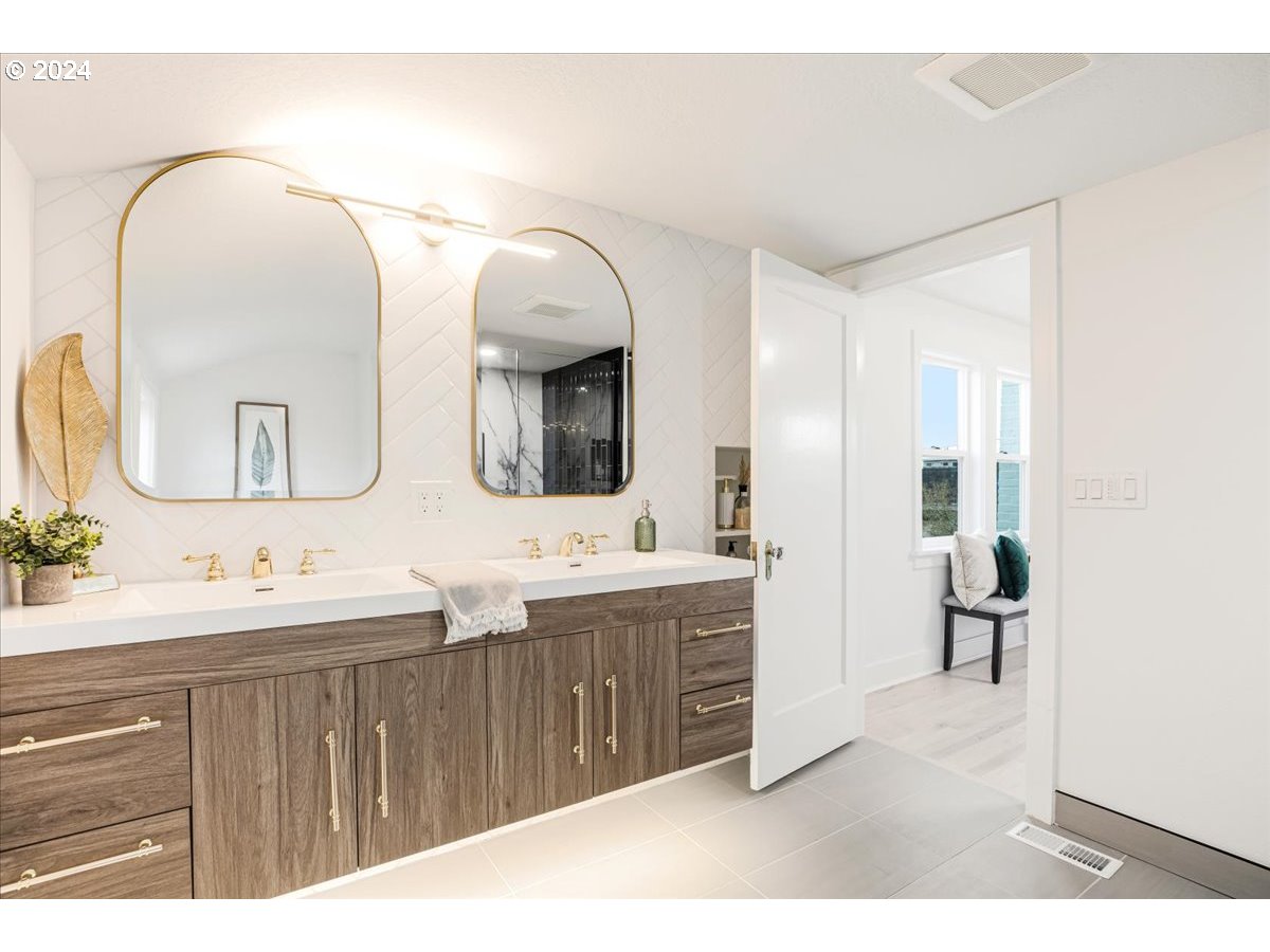 2639 North Sumner Street Portland, OR 97217 - Photo 20 of 46 a en suite bathroom with a double vanity sink and a mirror