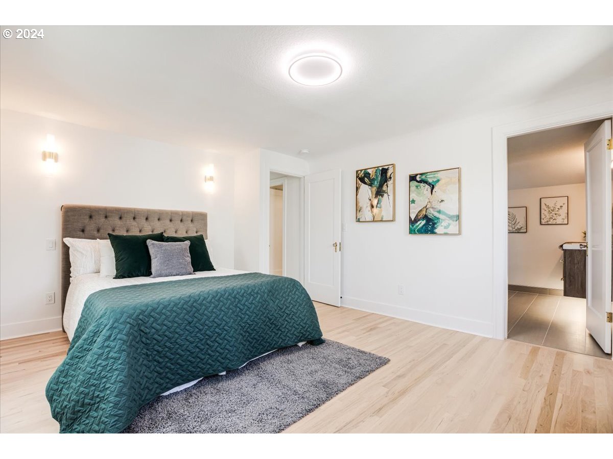 2639 North Sumner Street Portland, OR 97217 - Photo 23 of 46 a bedroom with a bed and wooden floor