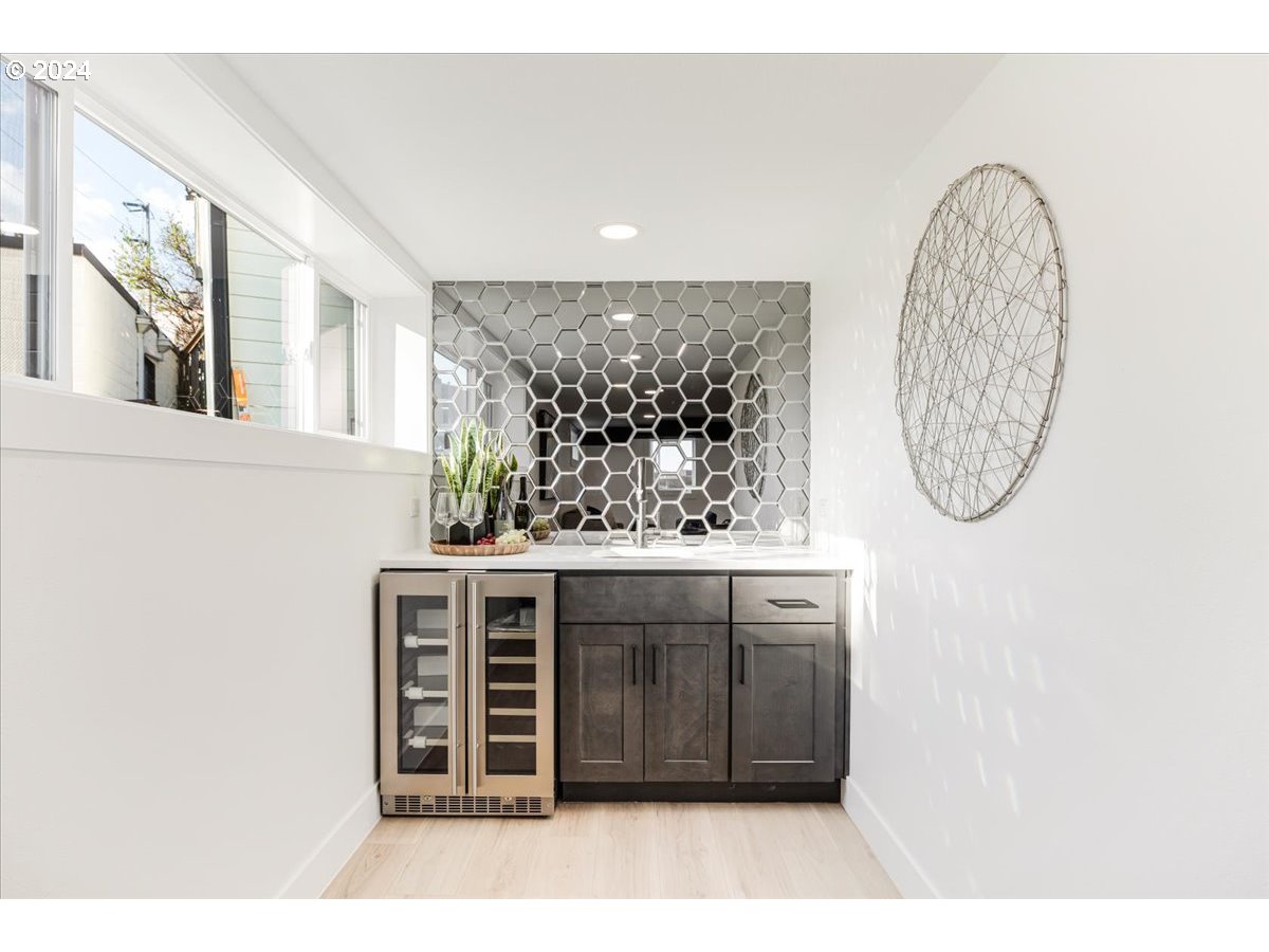 2639 North Sumner Street Portland, OR 97217 - Photo 32 of 46 a bathroom with a granite countertop sink a mirror and a window