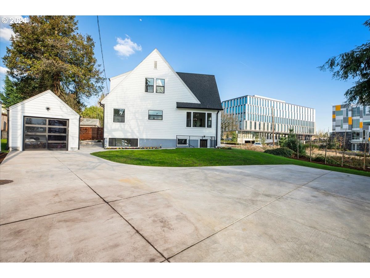 2639 North Sumner Street Portland, OR 97217 - Photo 42 of 46 a front view of a house with a yard and garage