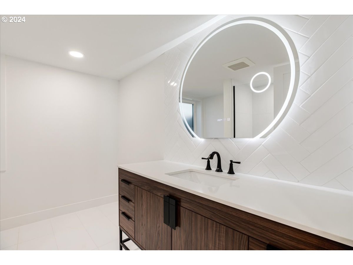 2639 North Sumner Street Portland, OR 97217 - Photo 43 of 46 a bathroom with a sink and a mirror