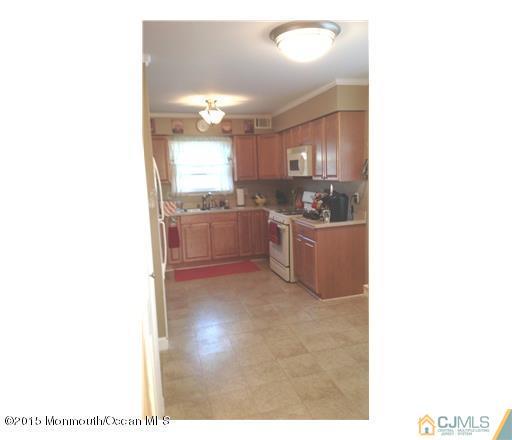 45 Starlight Road Howell, NJ 07731 - Photo 4 of 14 a kitchen with kitchen island a sink stainless steel appliances and cabinets