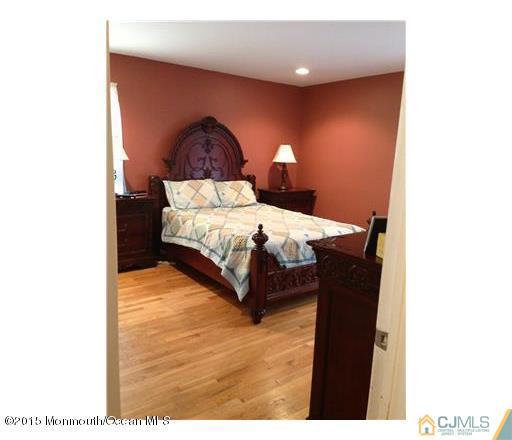 45 Starlight Road Howell, NJ 07731 - Photo 7 of 14 a bed room with a bed and a chair