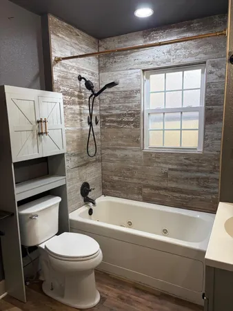 a bathroom with a toilet and a shower