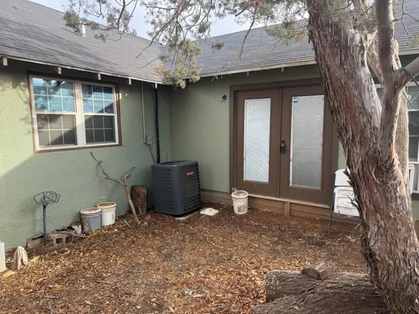 a view of a backyard with table and chairs and potted plants
