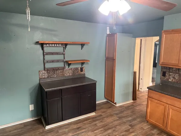 a kitchen with stainless steel appliances a sink cabinets and wooden floor