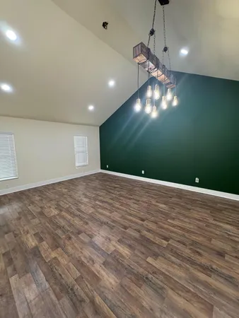 a view of a livingroom with a ceiling fan and window