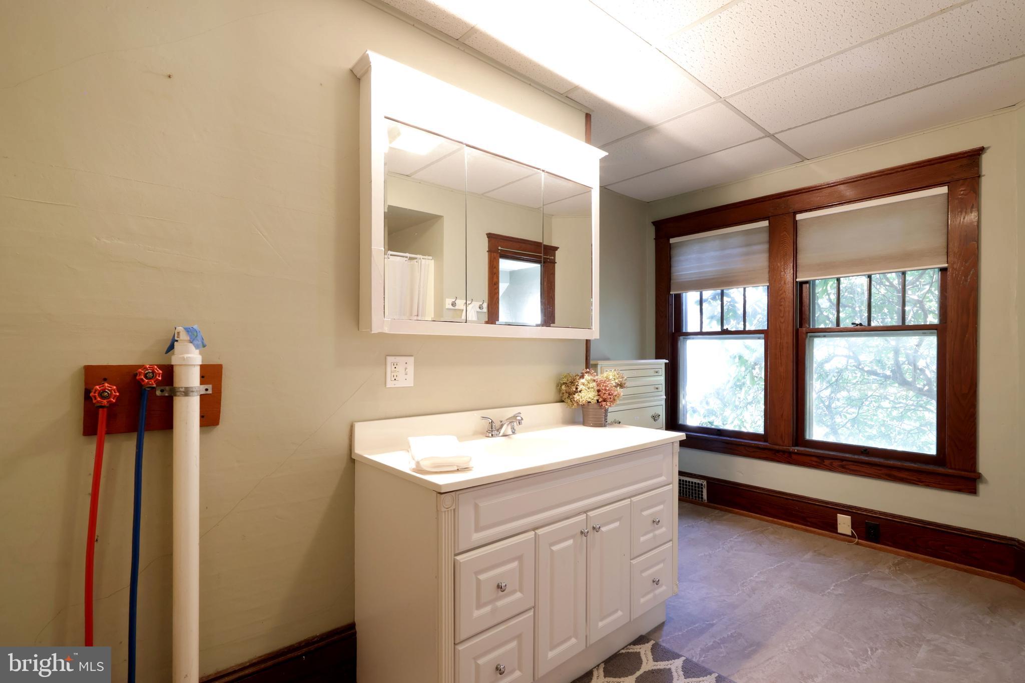 1343 Penns Creek Road Coburn, PA 16832 - Photo 23 of 92 a bathroom with a granite countertop sink and a mirror