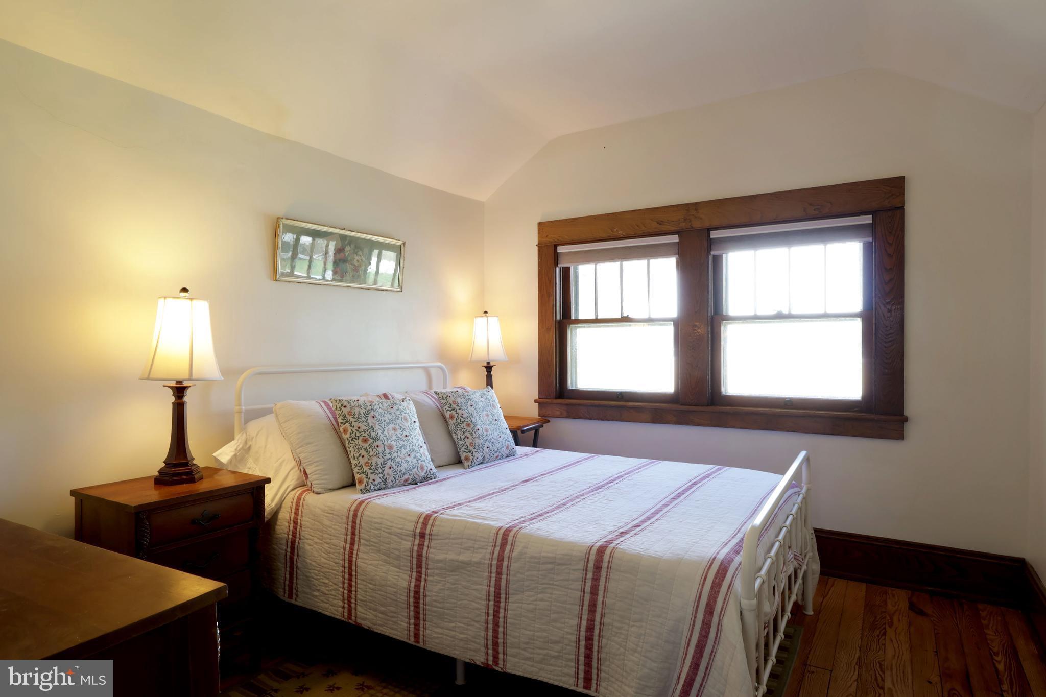 1343 Penns Creek Road Coburn, PA 16832 - Photo 28 of 92 a bedroom with a bed and a lamp next to a window