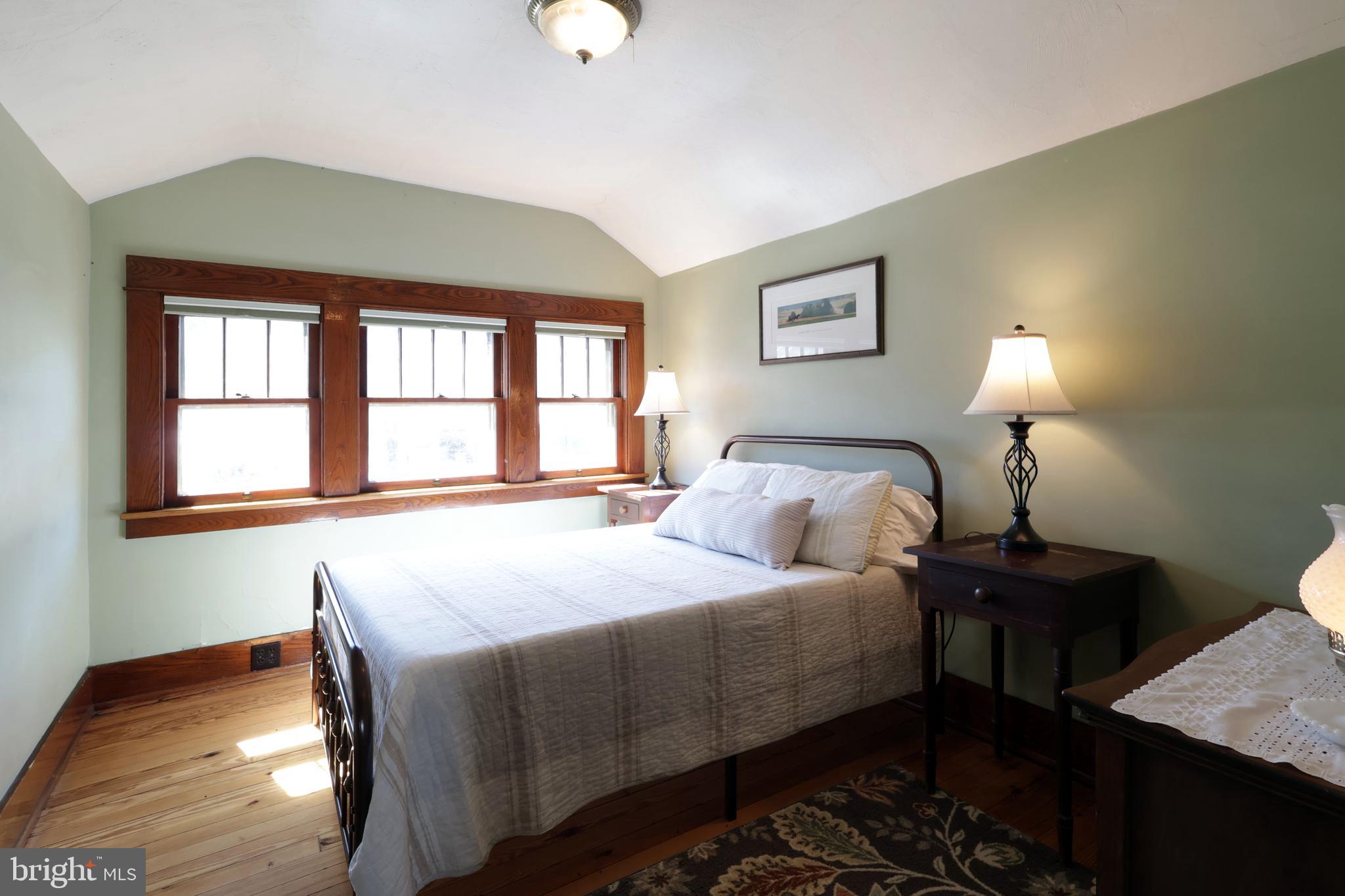 1343 Penns Creek Road Coburn, PA 16832 - Photo 33 of 92 a bedroom with a bed and a lamp next to a window