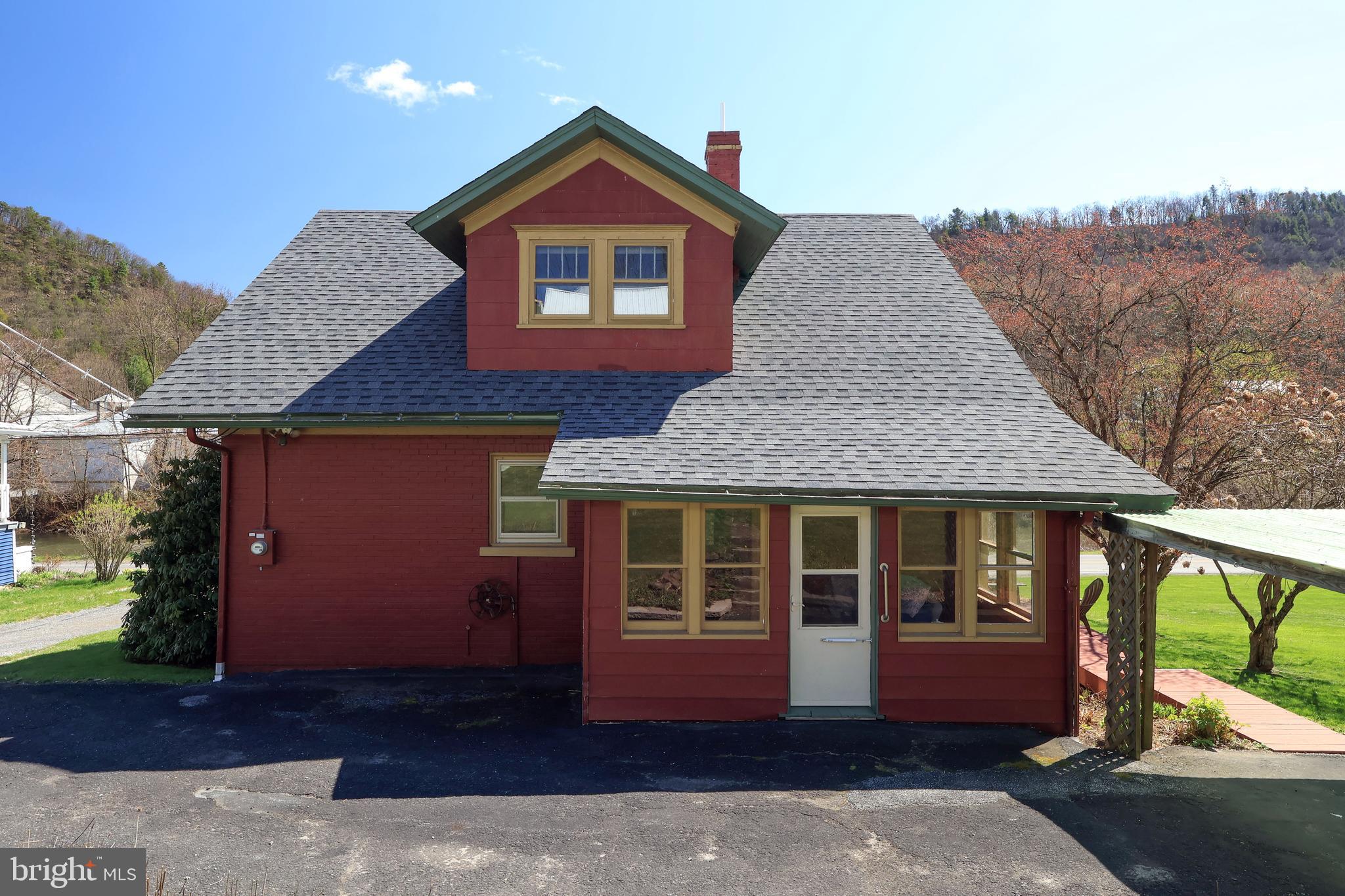 1343 Penns Creek Road Coburn, PA 16832 - Photo 39 of 92 a front view of a house with a yard and garage