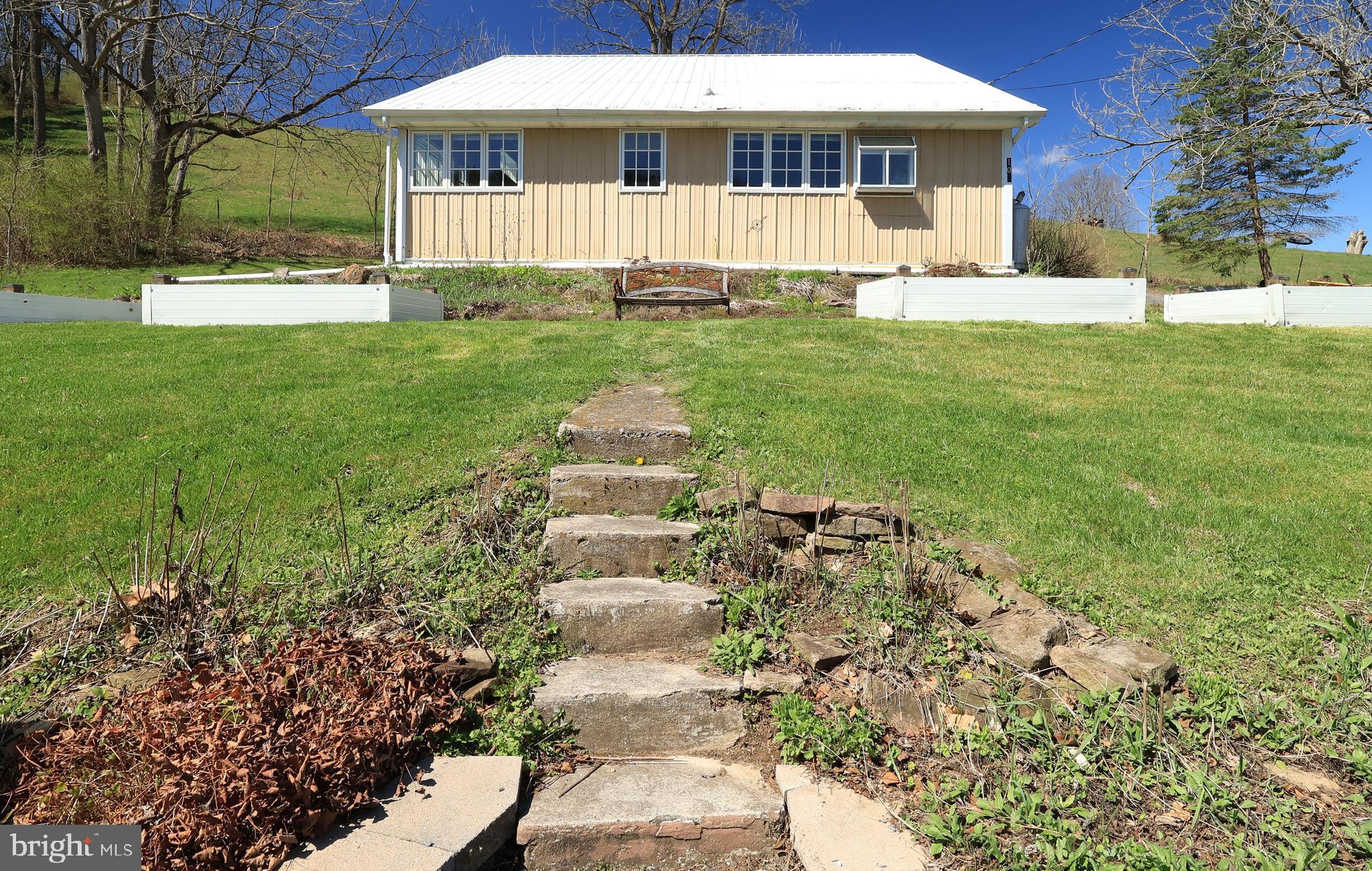 1343 Penns Creek Road Coburn, PA 16832 - Photo 45 of 92 a front view of a house with a garden